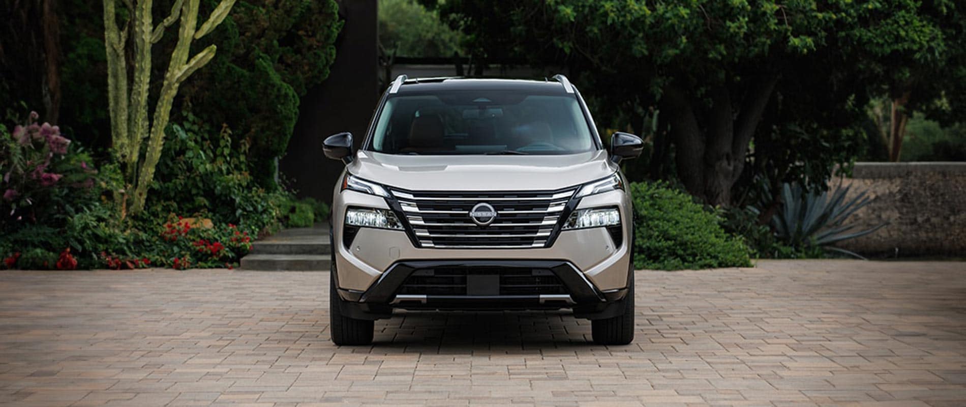 A front view of a silver Nissan Rogue